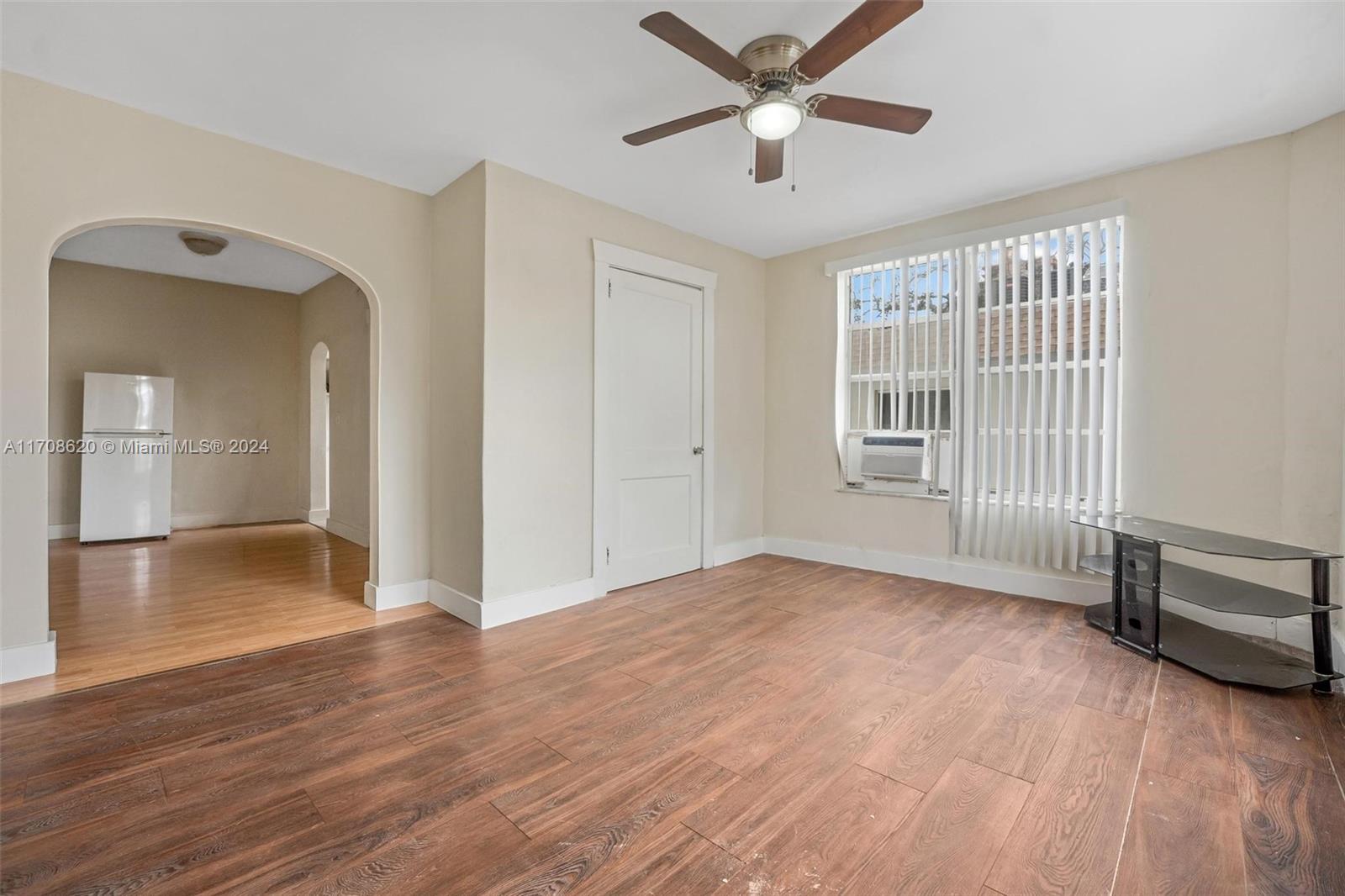 wooden floor in an empty room with a window