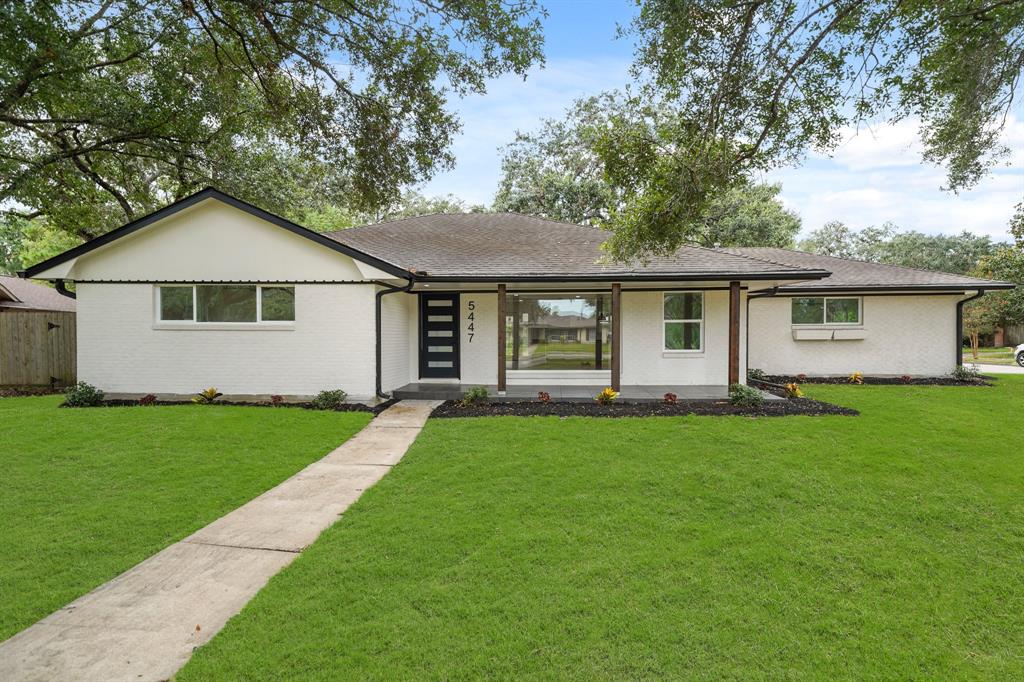 a front view of house with yard and green space