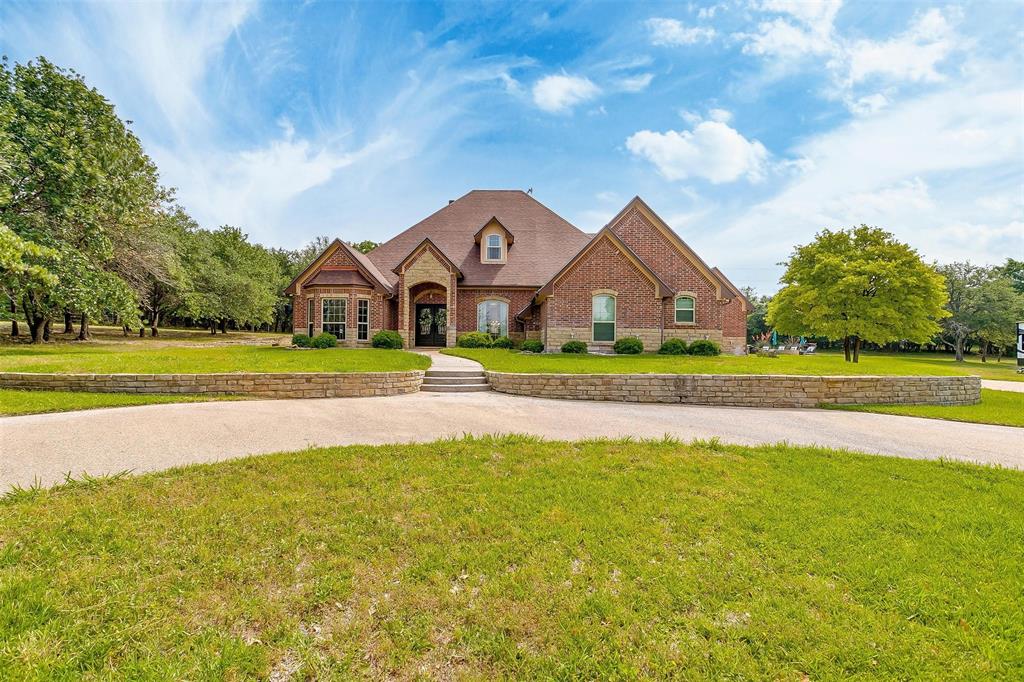 a front view of a house with a big yard