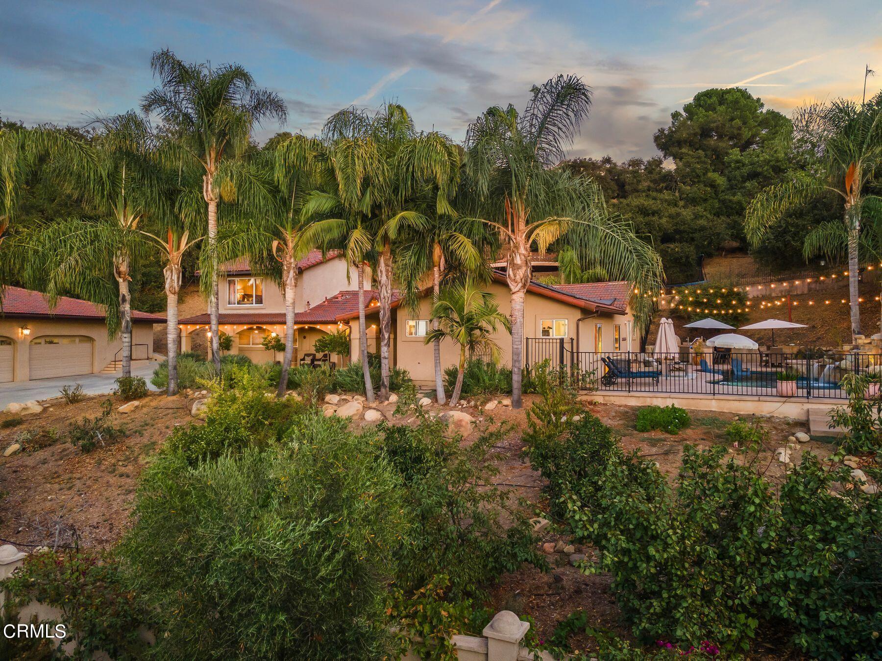 a view of multiple houses with a yard and swimming pool