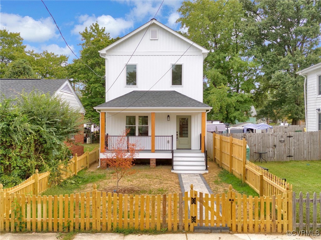 a front view of house with yard and trees in the background