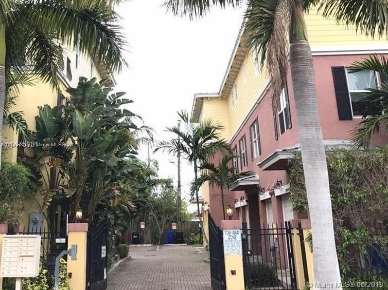 a view of multiple house with a palm tree