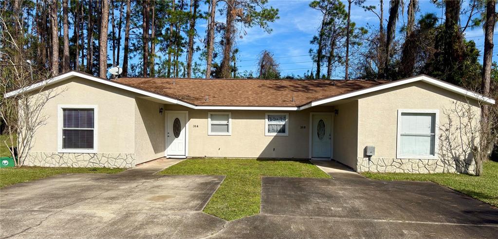 a view of a house with a yard and garage