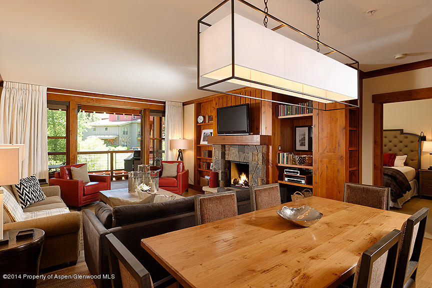 a living room with fireplace furniture and a large window