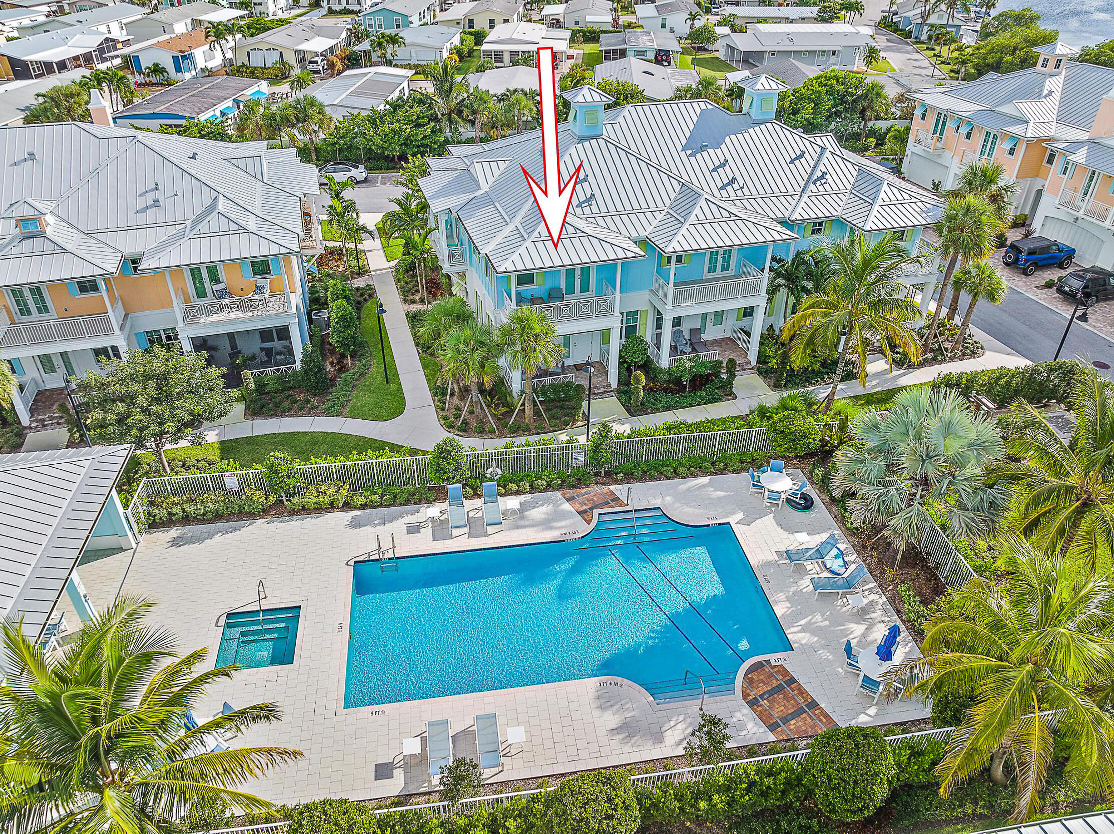 an aerial view of a house with garden space and street view