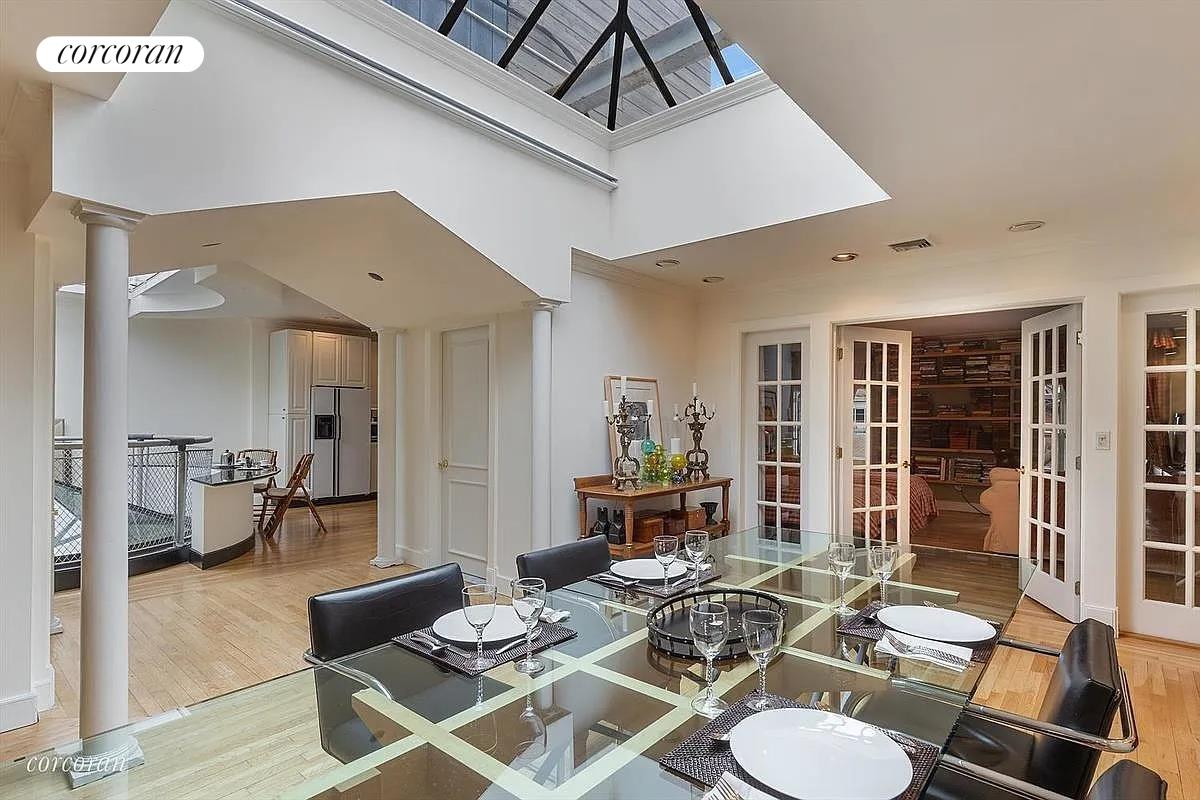 a living room with furniture and a dining table