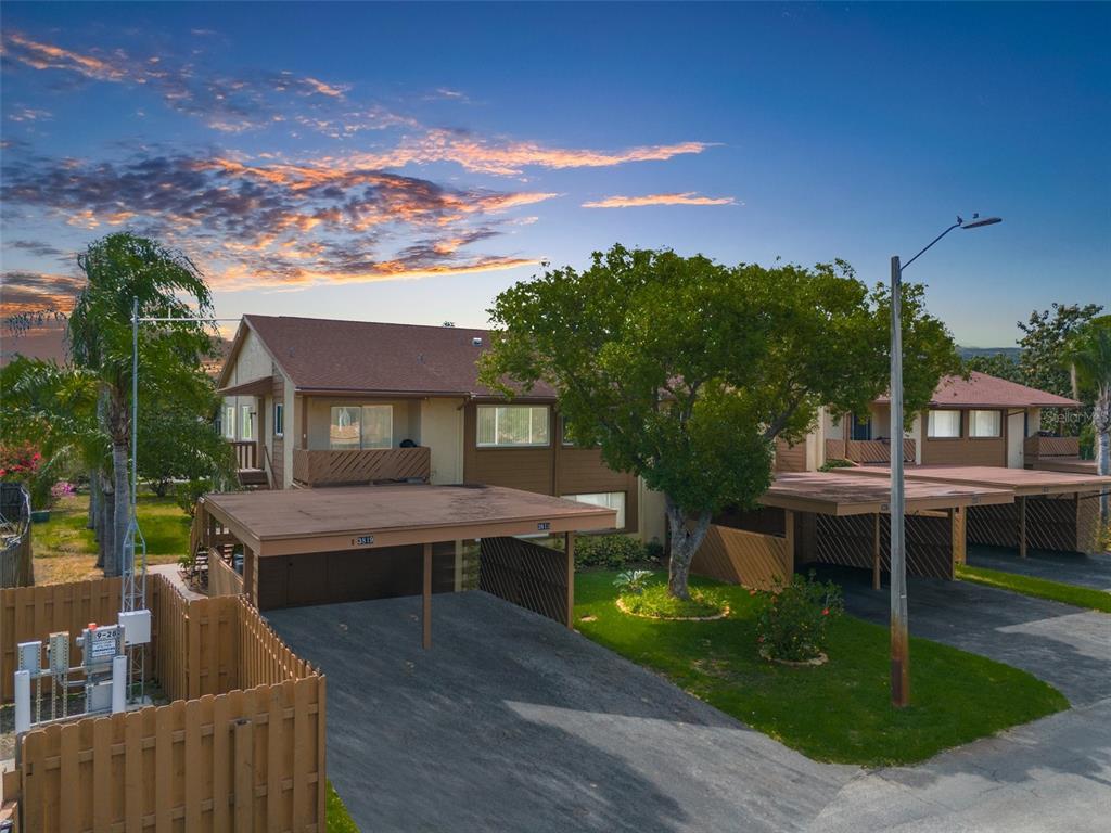 a view of house with roof deck and seating space