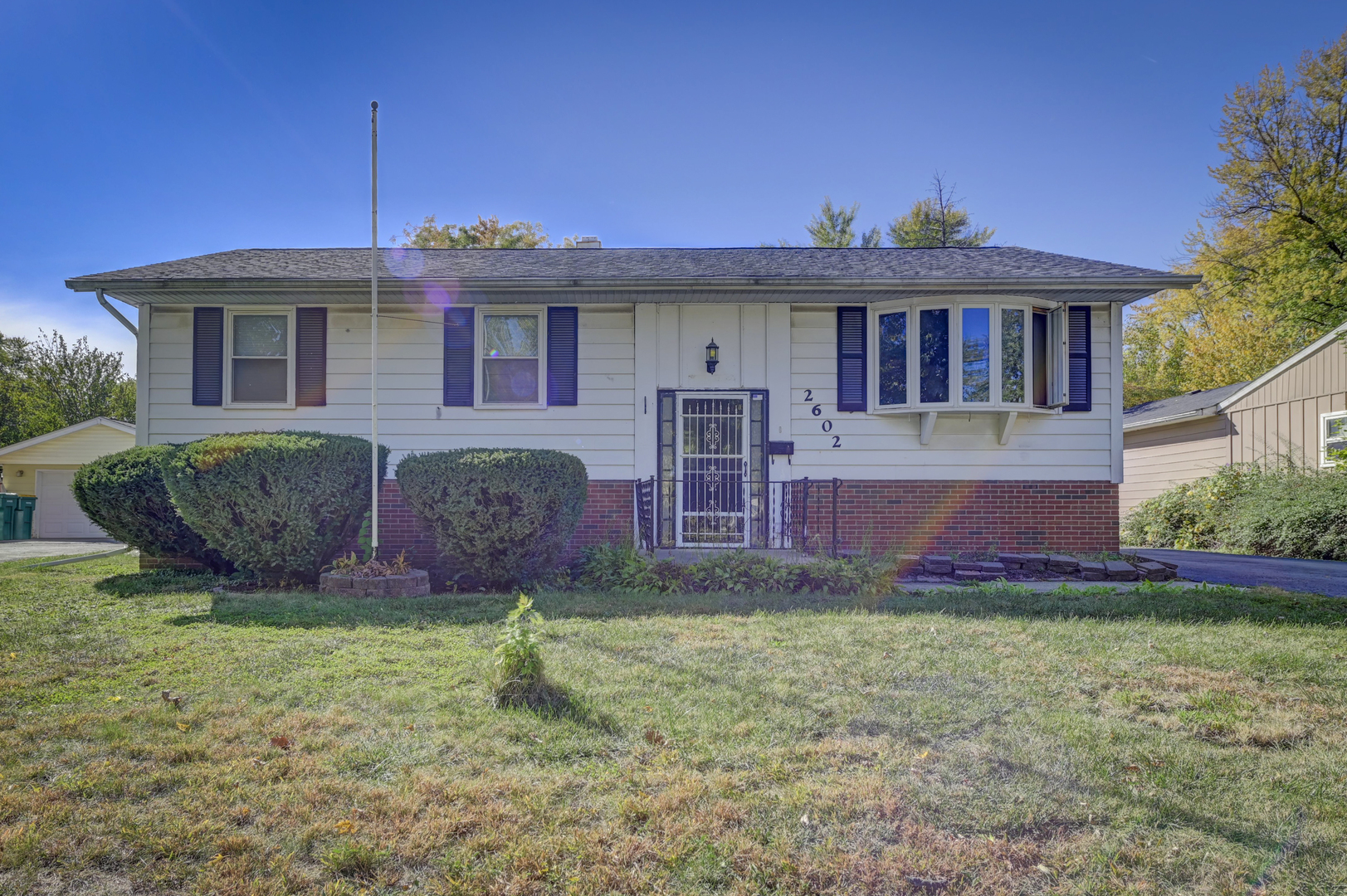 a front view of a house with a garden and plants