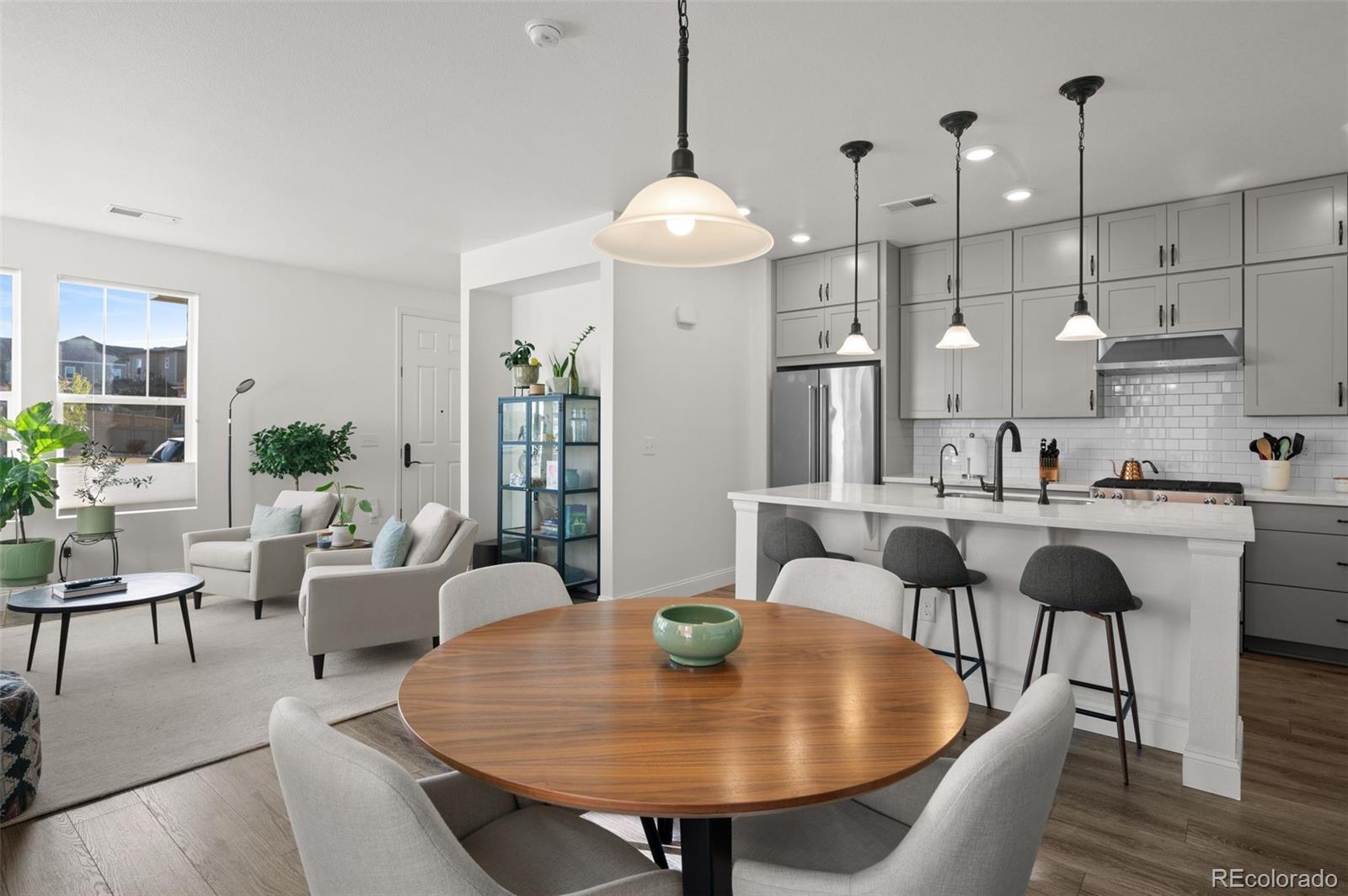 a view of a dining room with furniture and wooden floor