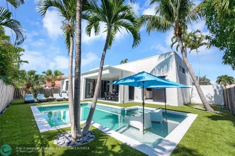 a view of a house with swimming pool and porch with furniture