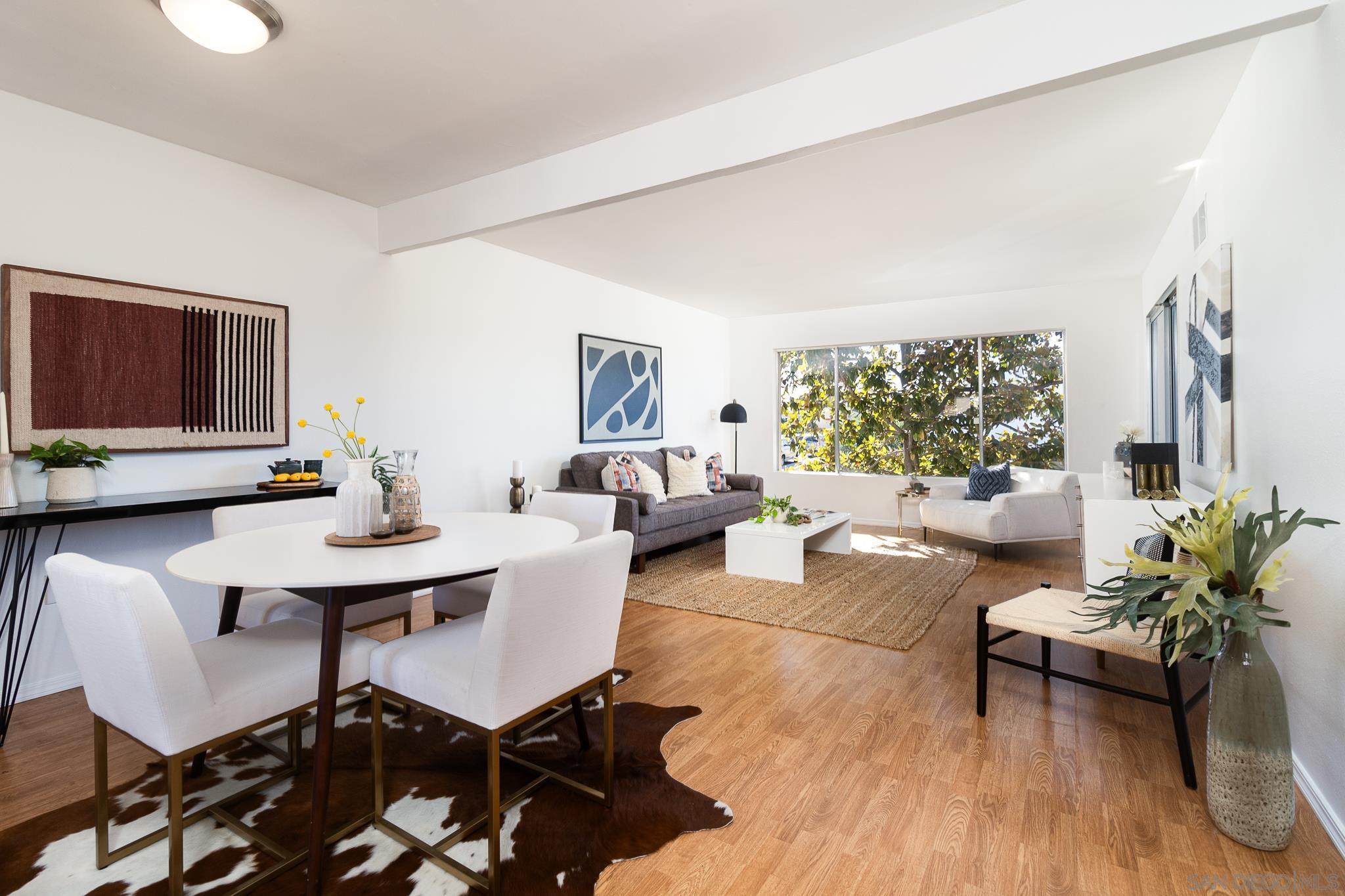 a living room with furniture potted plant and a window