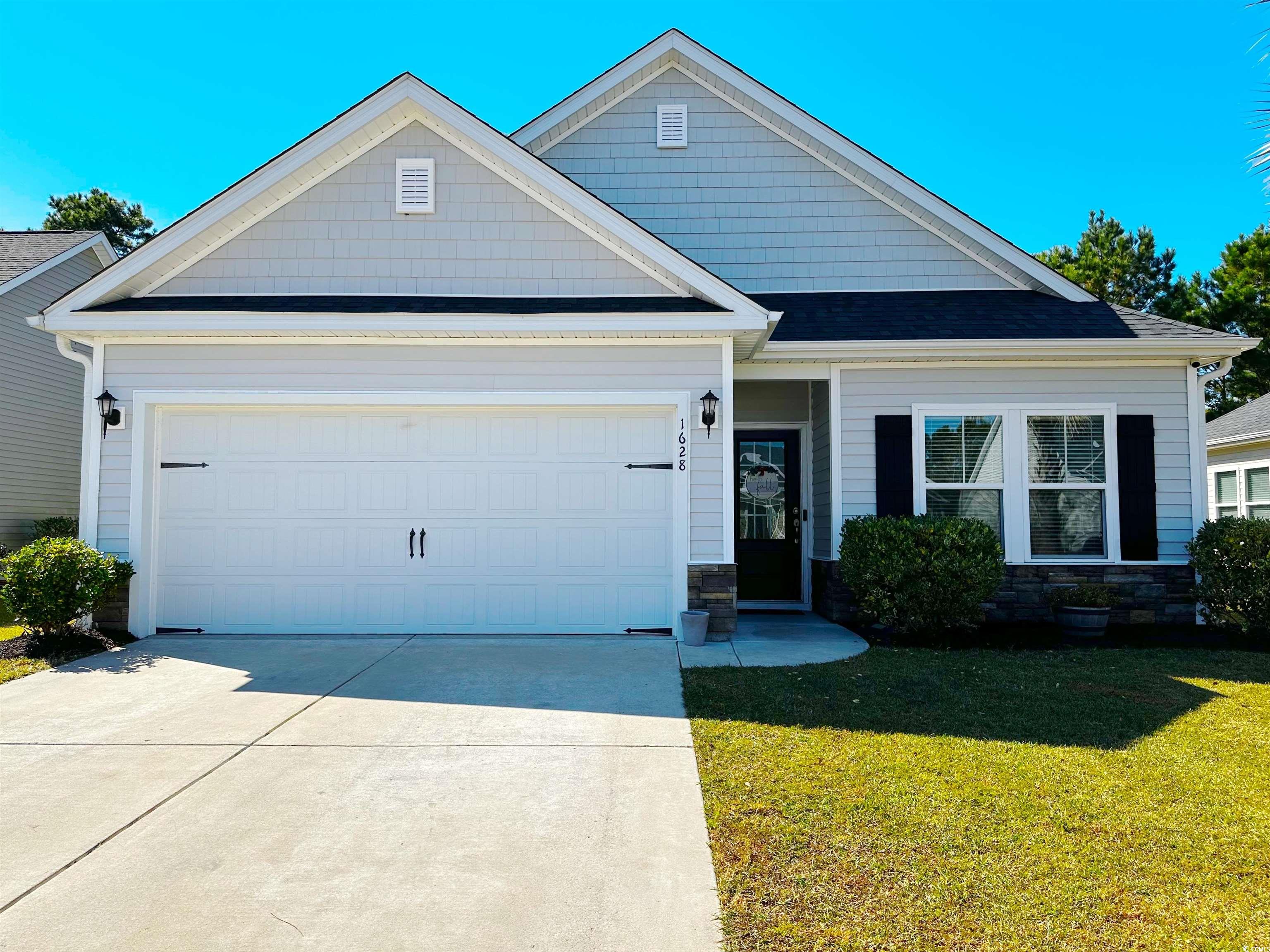 Craftsman-style home featuring a garage and a fron