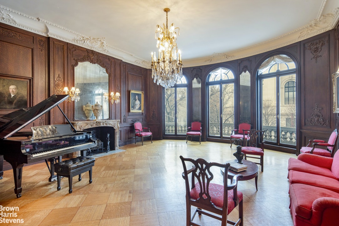 a living room with furniture a chandelier and a chandelier