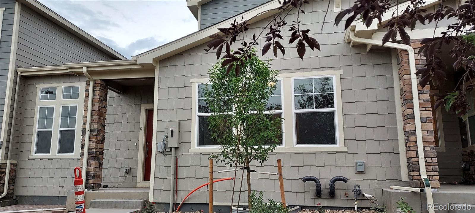 a view of a house with a window and potted plants