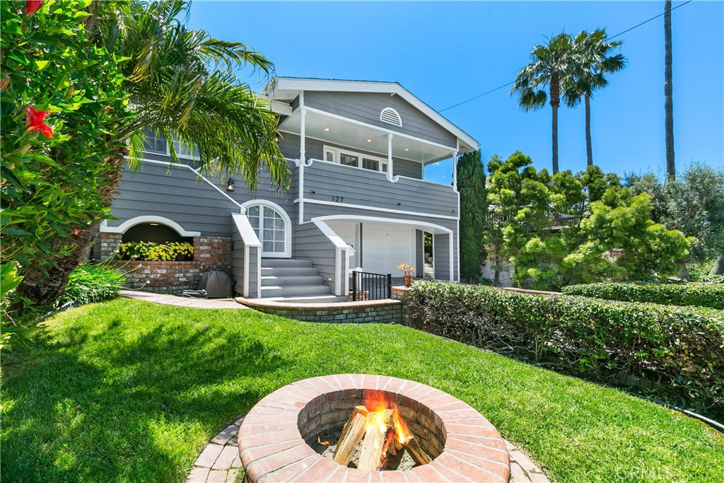 a front view of a house with a garden and plants