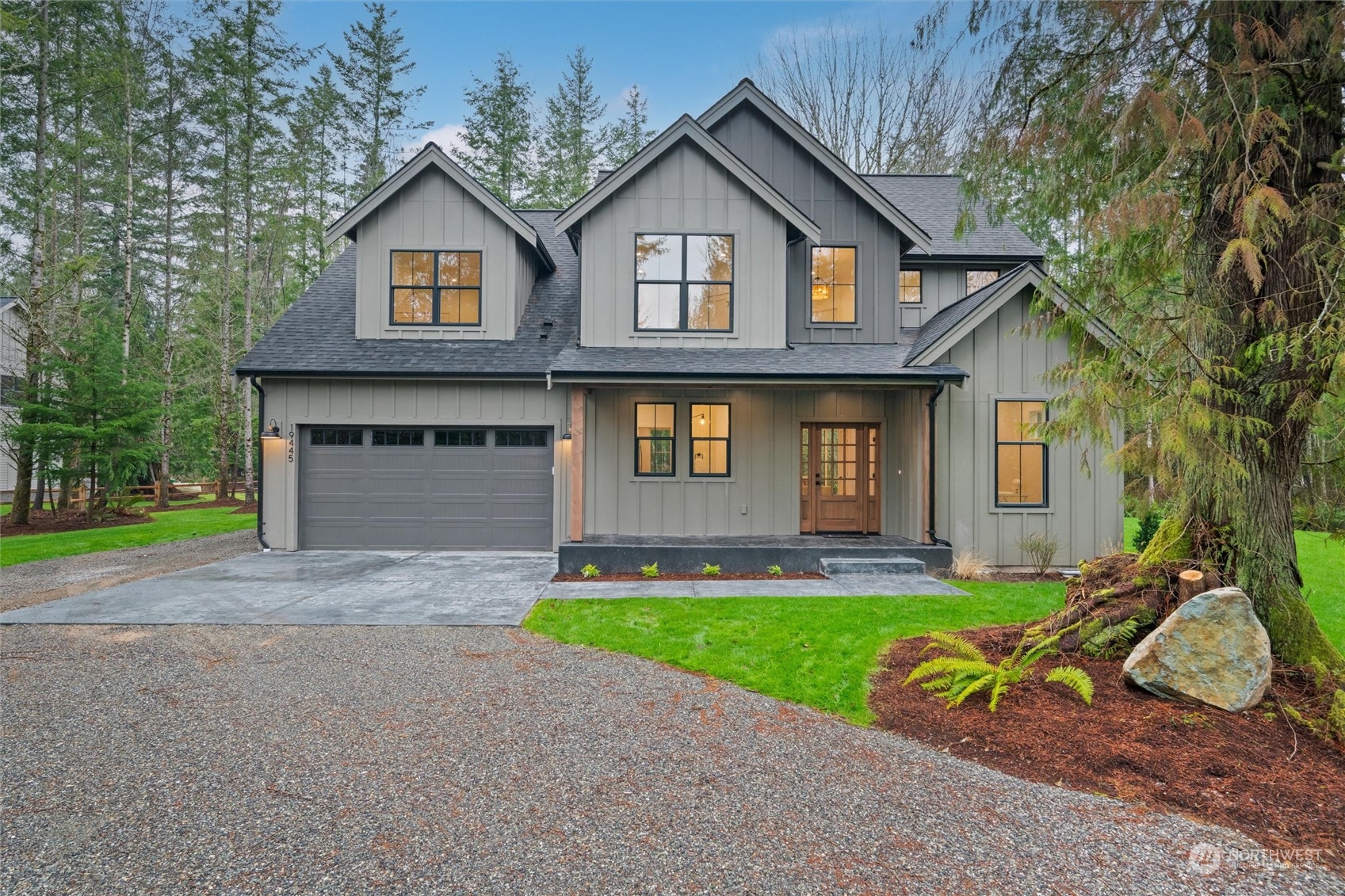 a front view of a house with a yard and garage