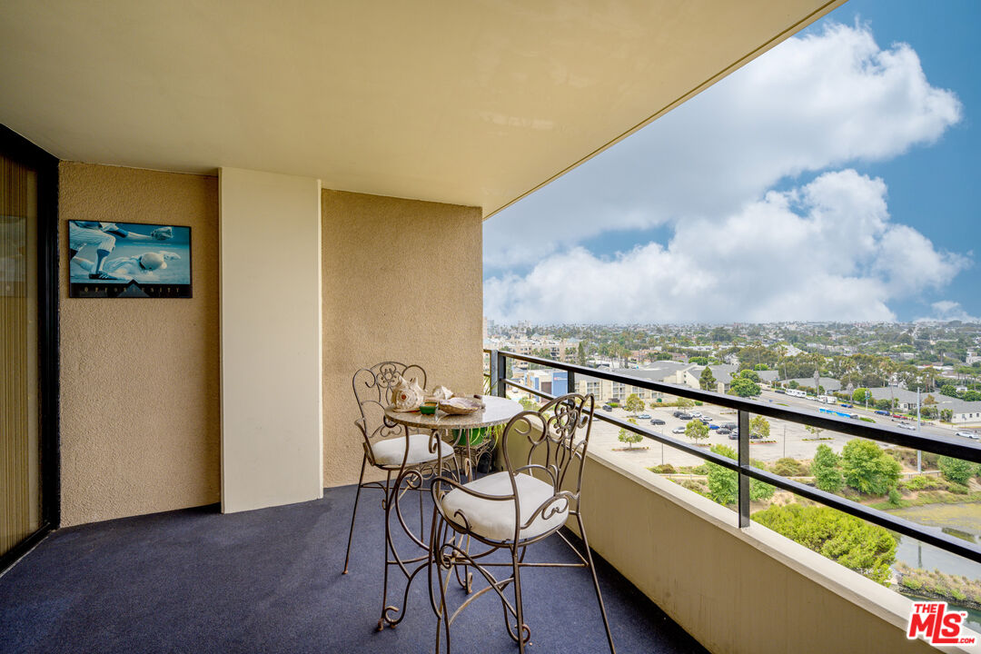 a view of a balcony with chairs