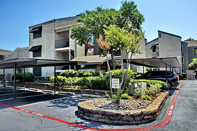 a front view of a house with a yard fountain and outdoor seating