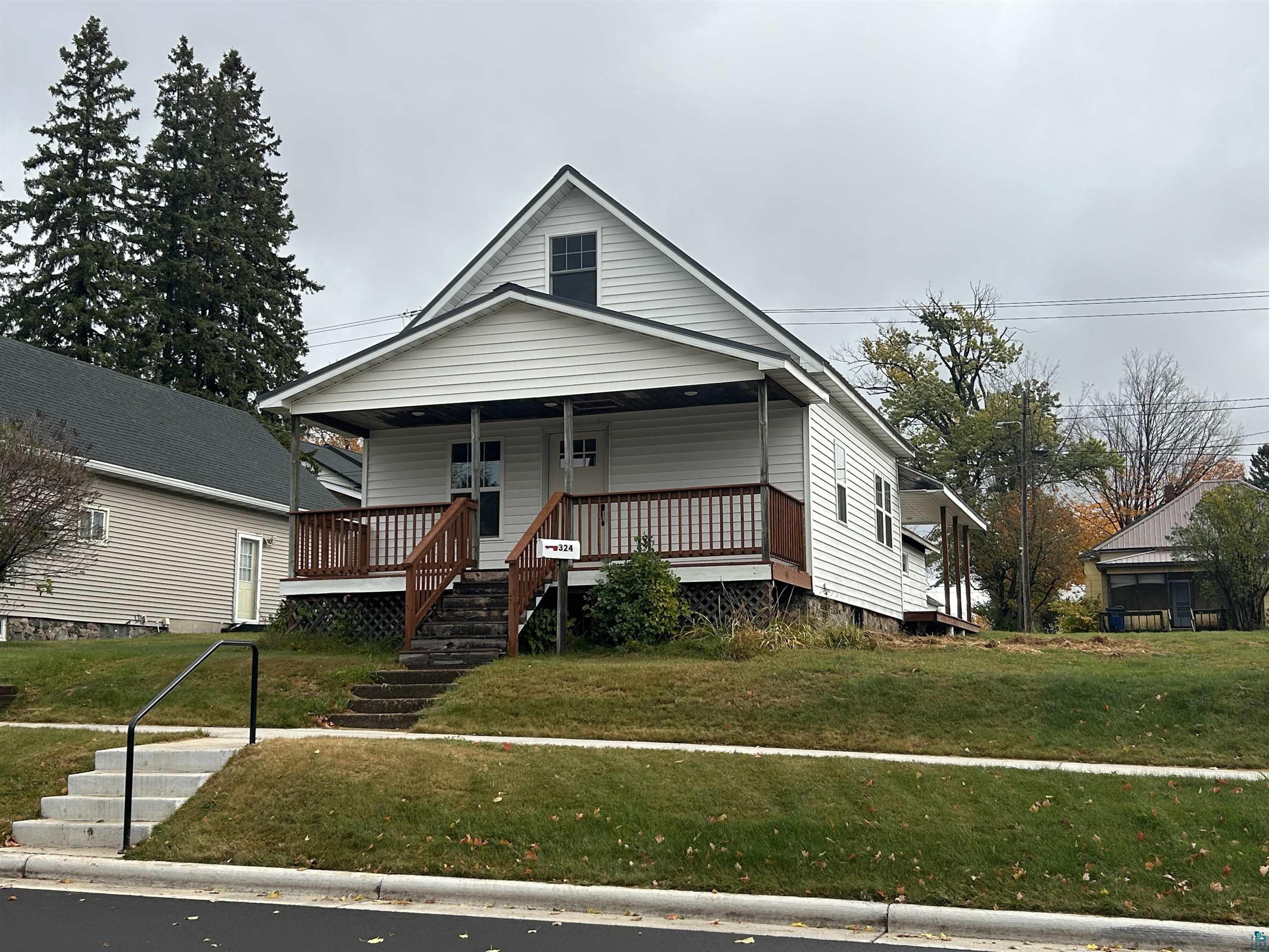 View of front of home featuring covered porch and a front yard