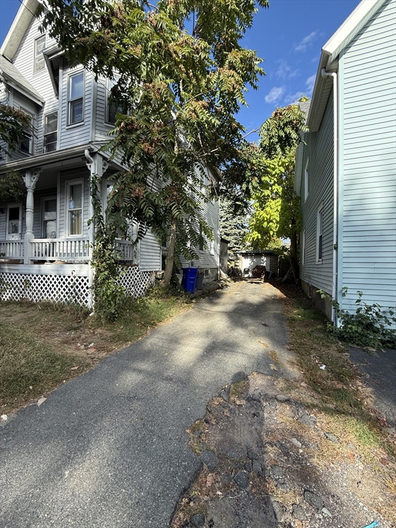 a view of a house with a tree and a yard