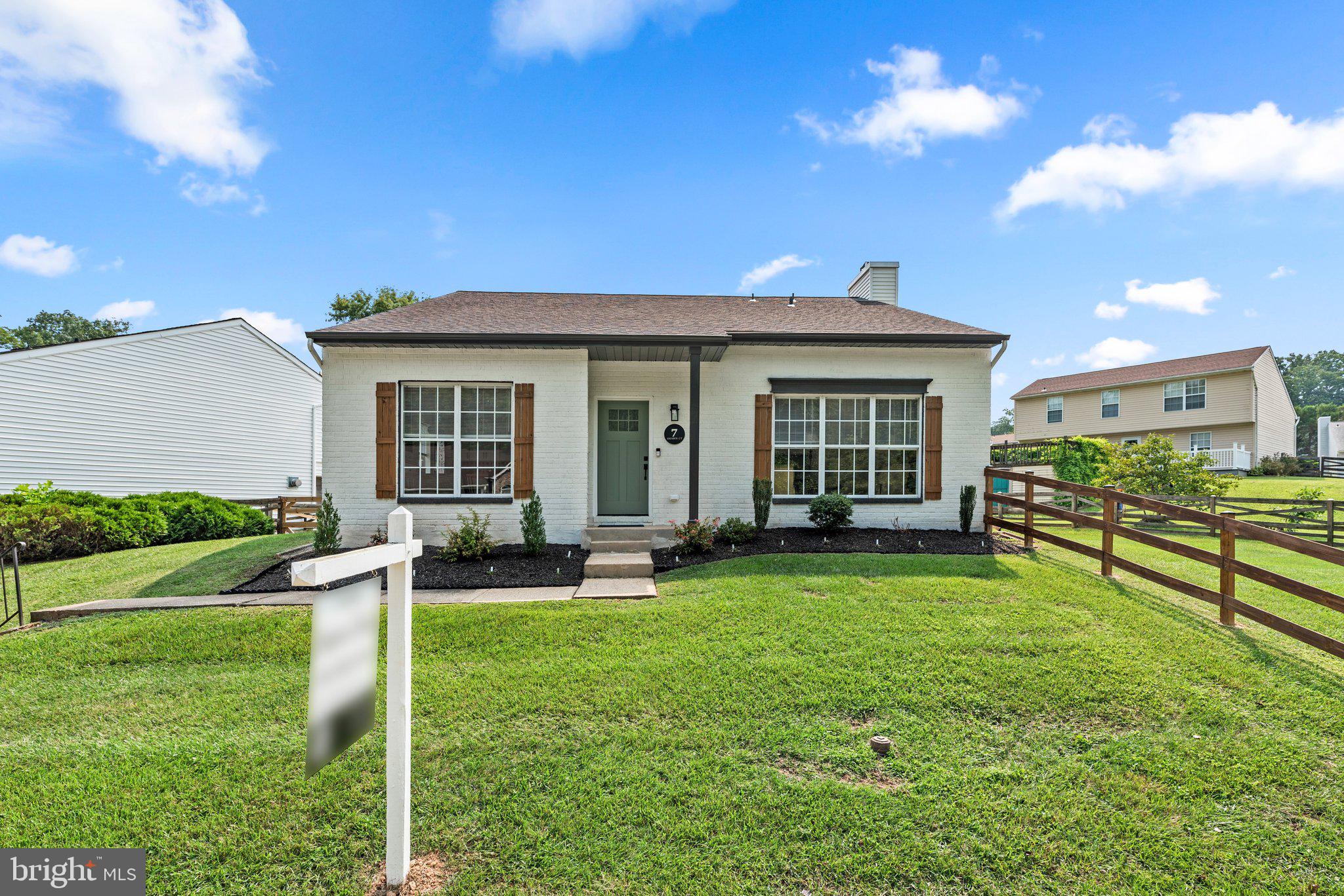 a view of a house with a yard and sitting area