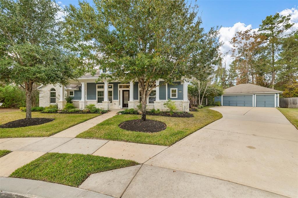 a front view of a house with yard and green space