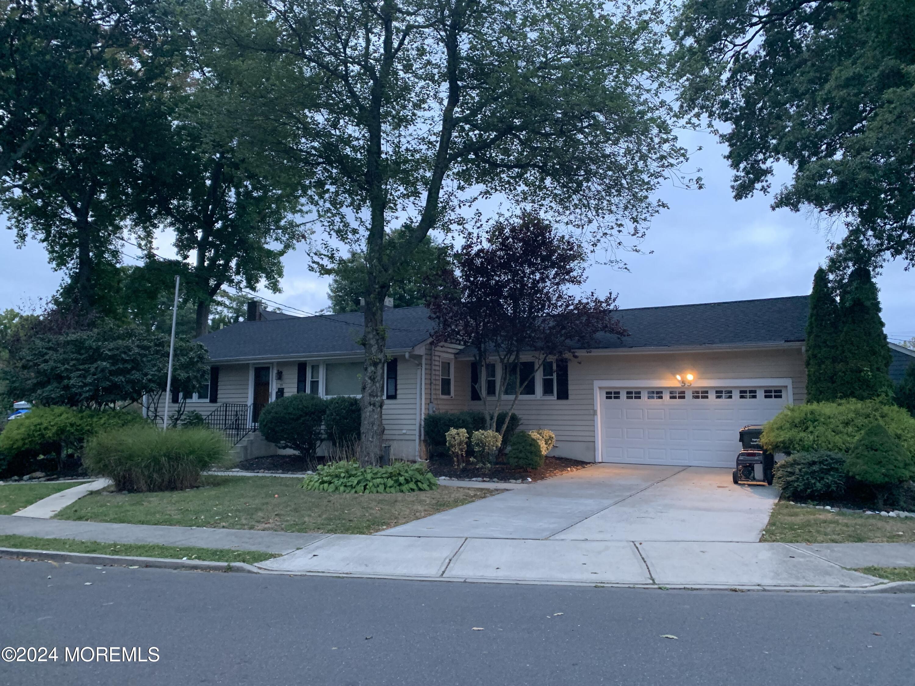 a front view of a house with a yard and a garage