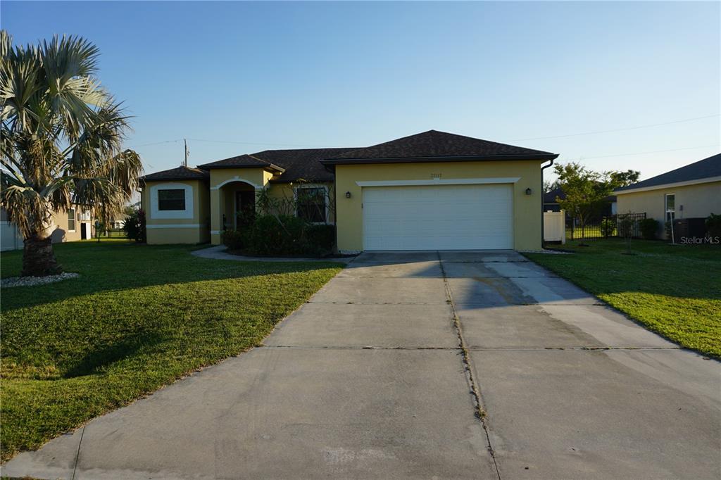 a front view of a house with a yard and garage