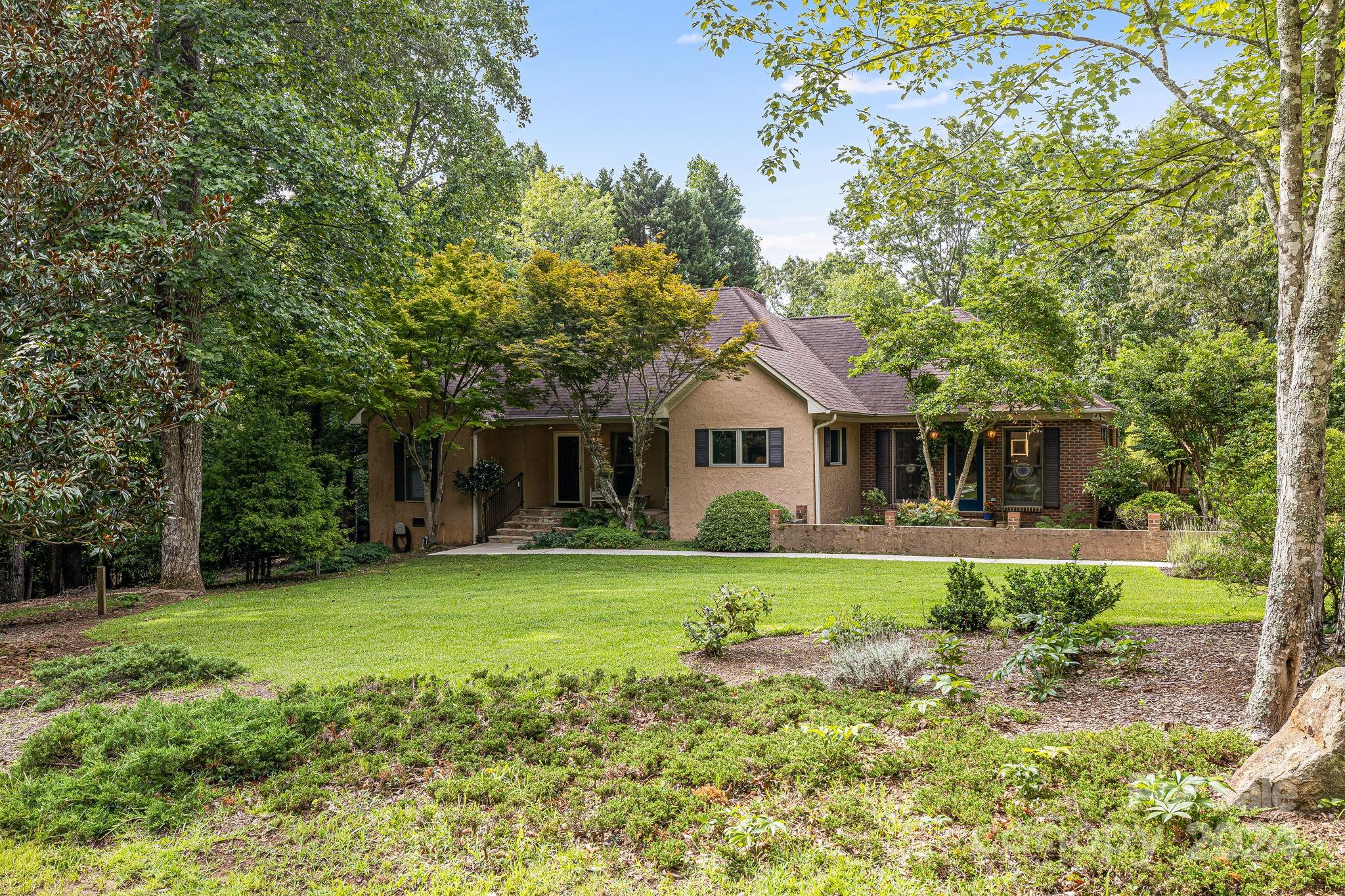 a front view of a house with a garden