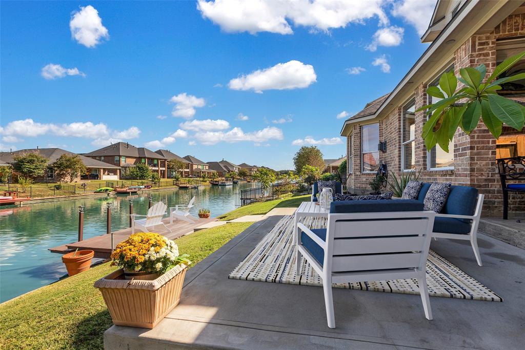 Virtually staged. This home's backyard features a large extended north-facing patio that overlooks the tranquil blue canal waters.