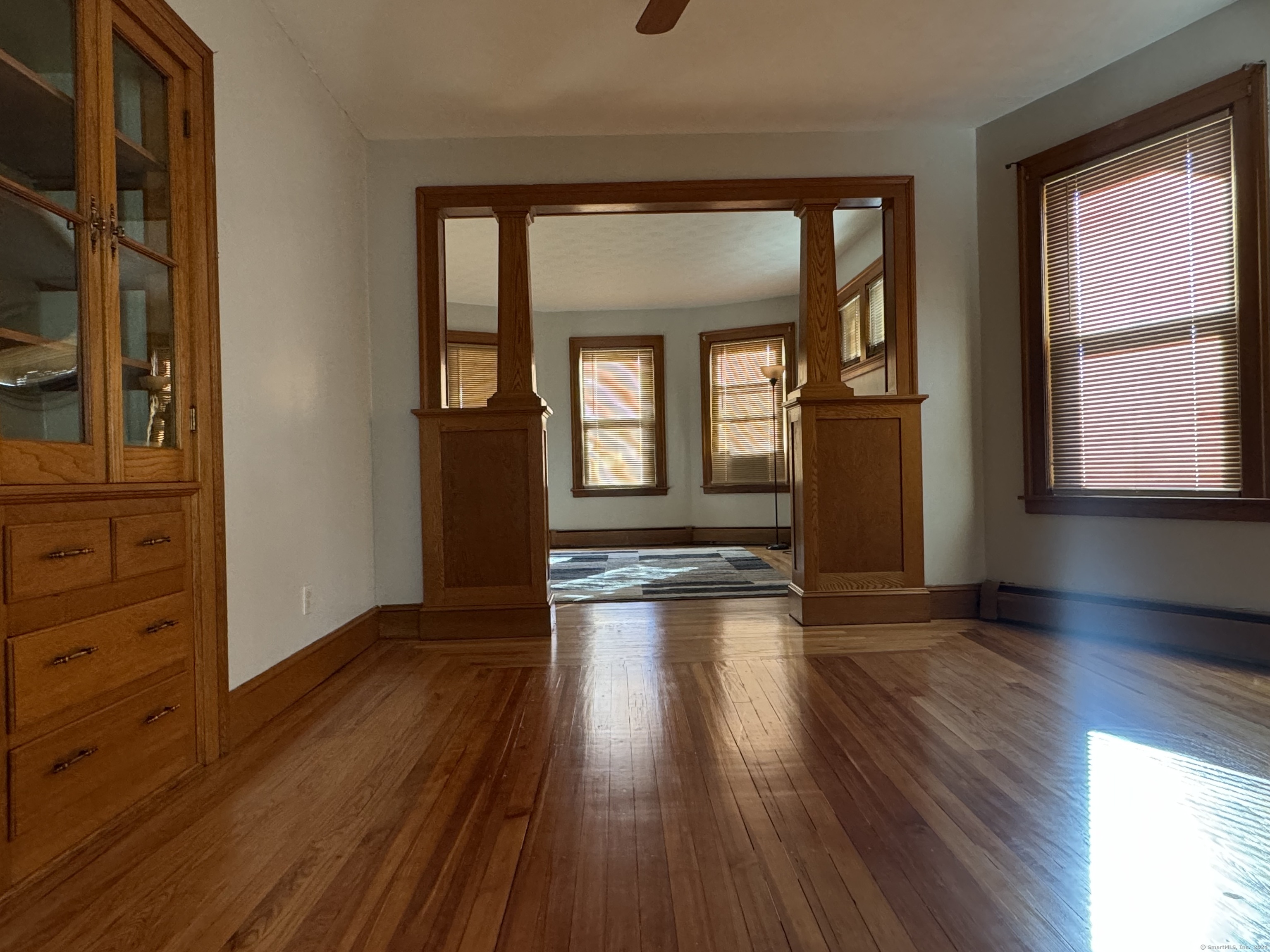 wooden floor in an empty room with a window