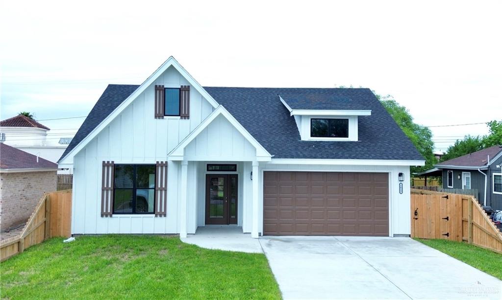 a front view of house with yard and garage