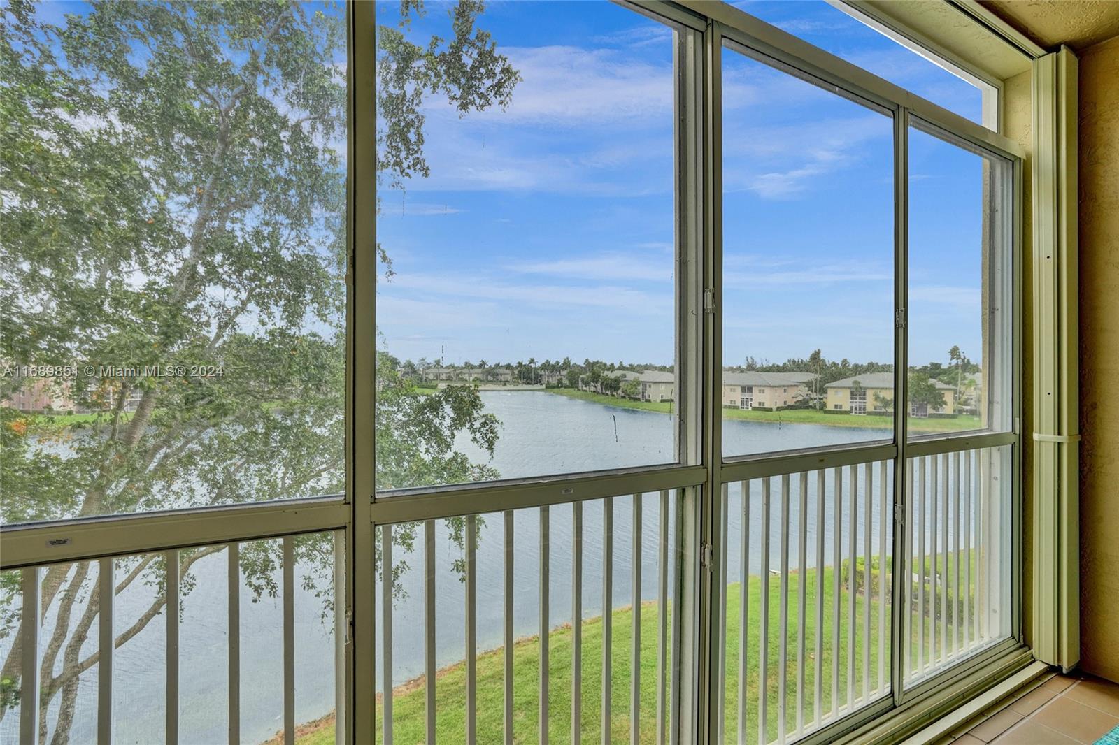 a view of a balcony with a floor to ceiling window with wooden fence