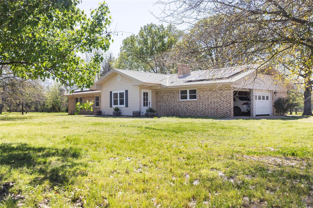 a front view of house with yard and green space