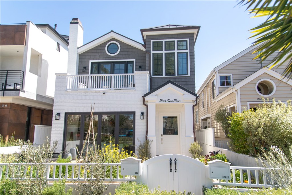 a front view of a house with a yard and potted plants