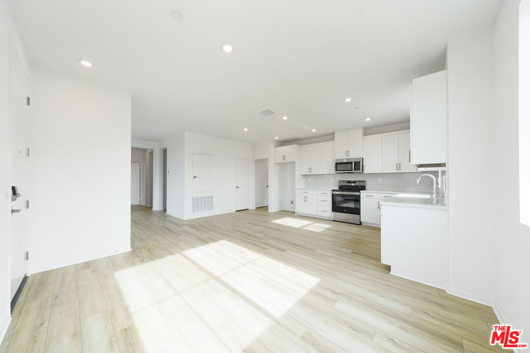 a view of kitchen appliances and cabinets