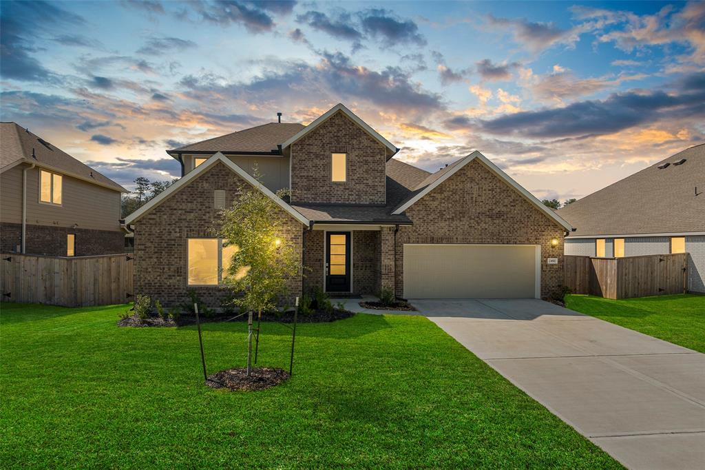 a front view of a house with a yard and garage