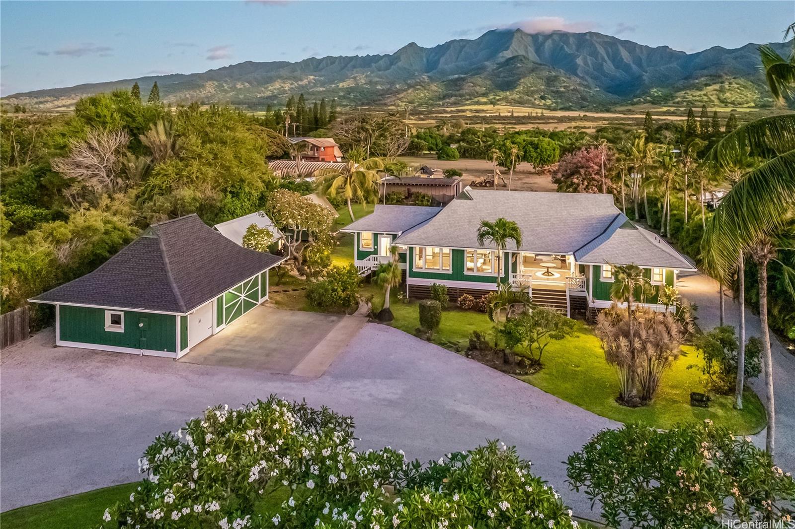 an aerial view of residential houses with outdoor space and trees