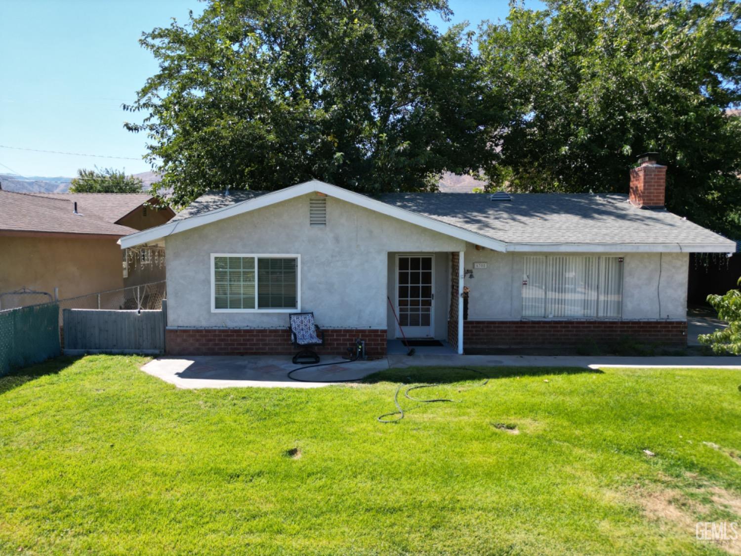 a view of a house with a yard and sitting area