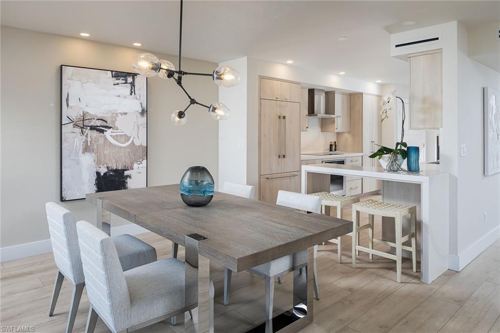 a view of a dining room with furniture and a chandelier