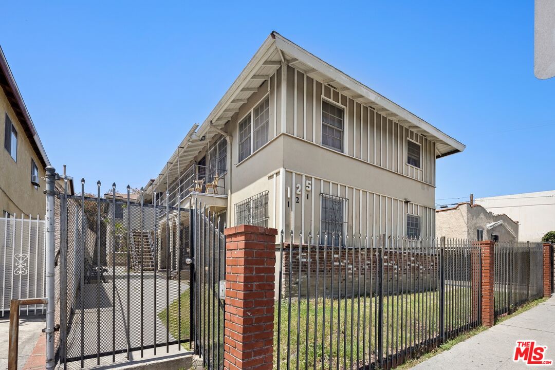 a front view of a house with iron fence