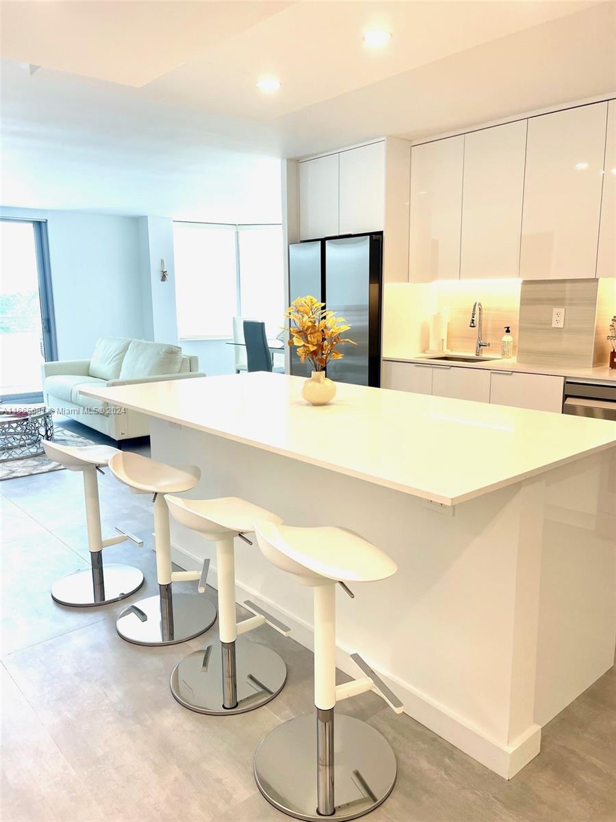 a kitchen with a table and chairs in it