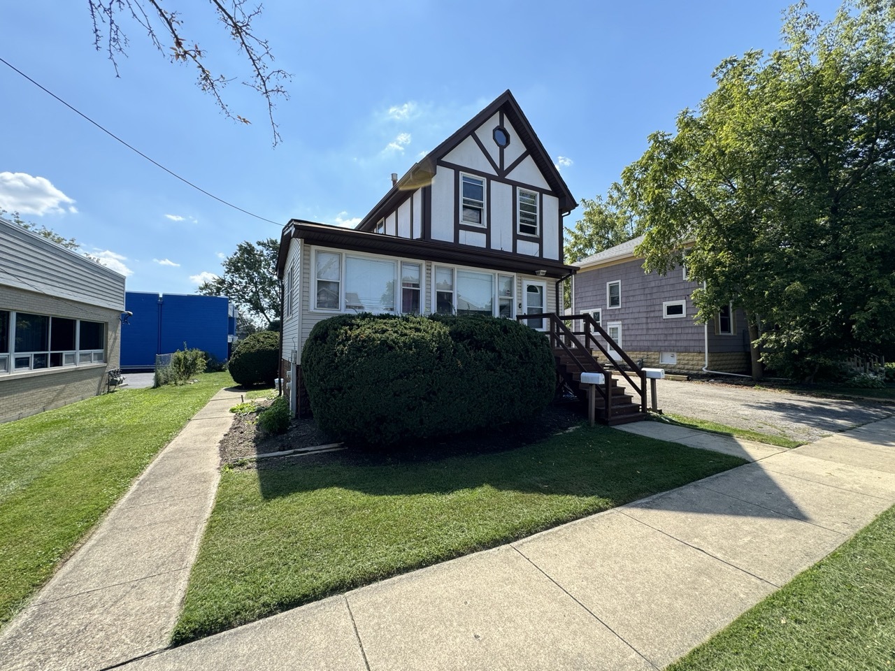 a front view of a house with a garden