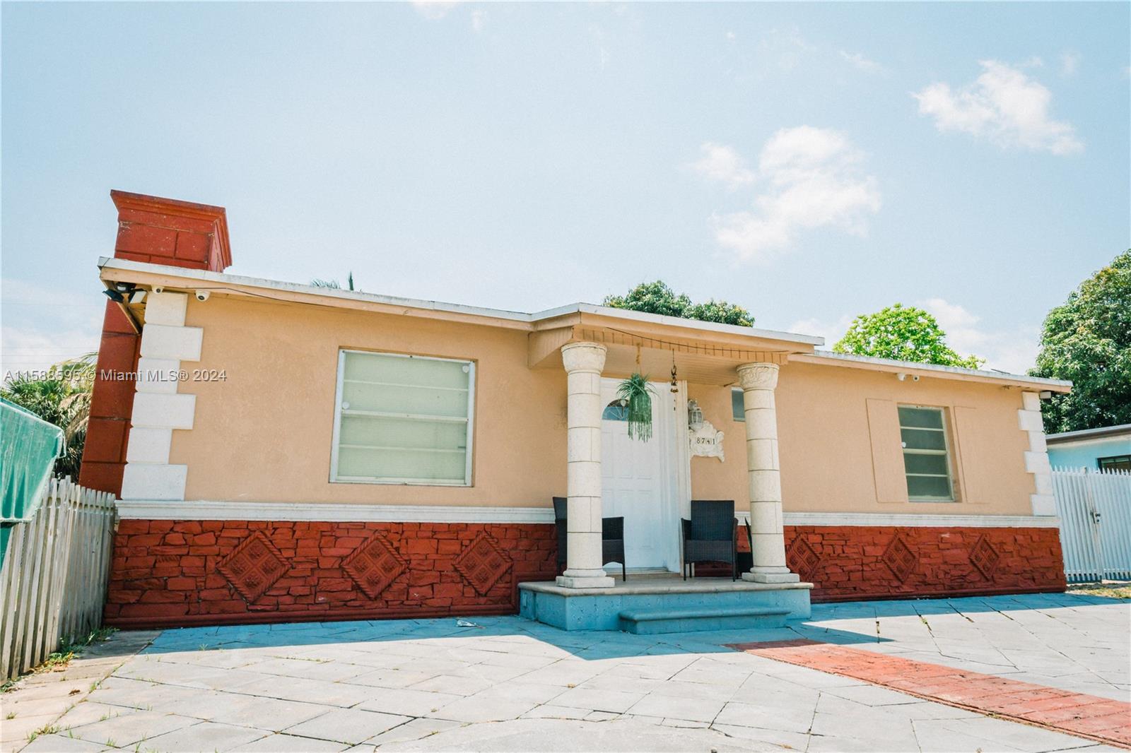 a front view of a house with a garden