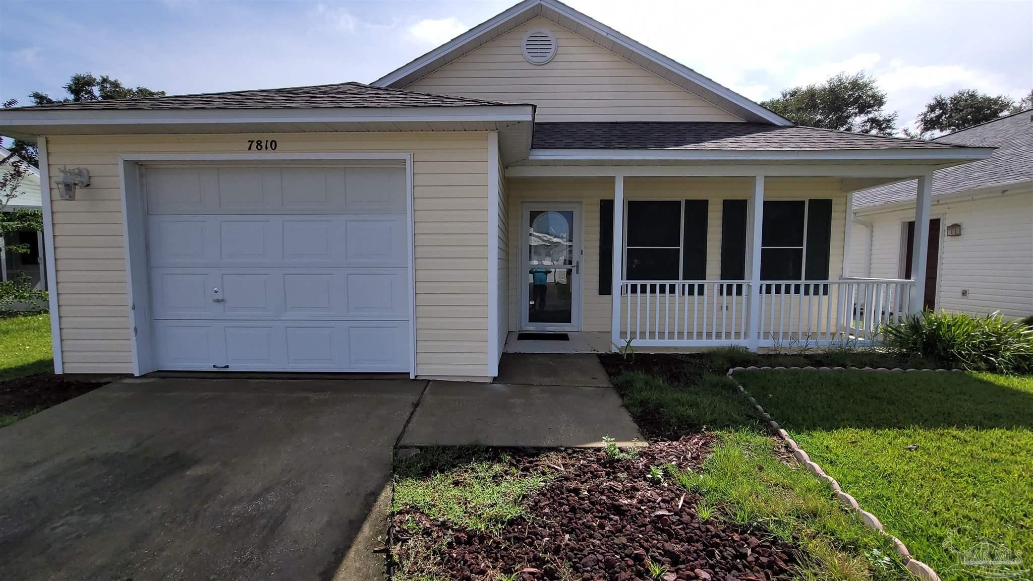 front view of a house with a garden