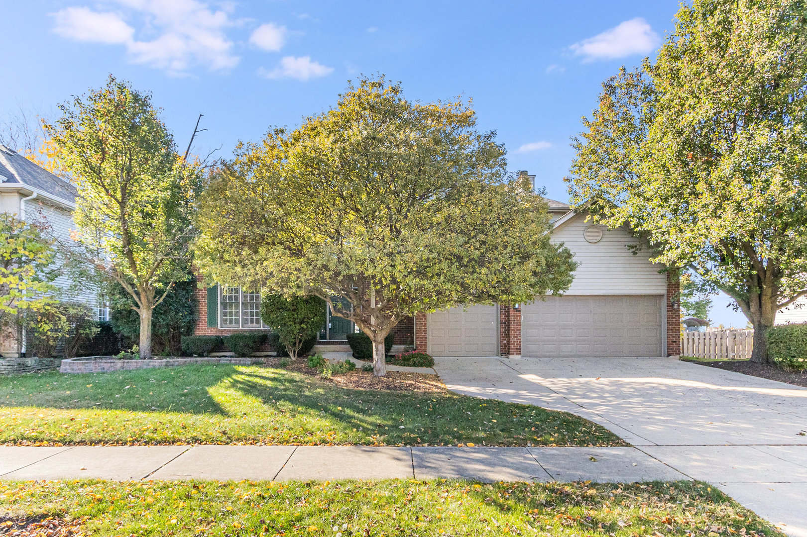 a view of a house with a yard and tree s