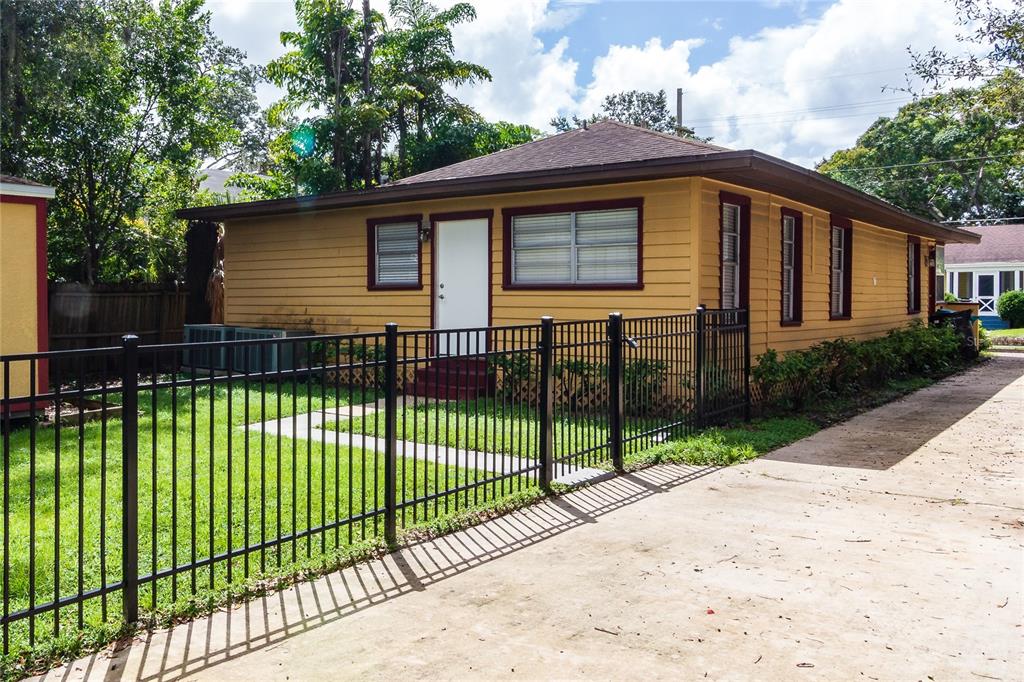 a view of a house with a small yard and plants