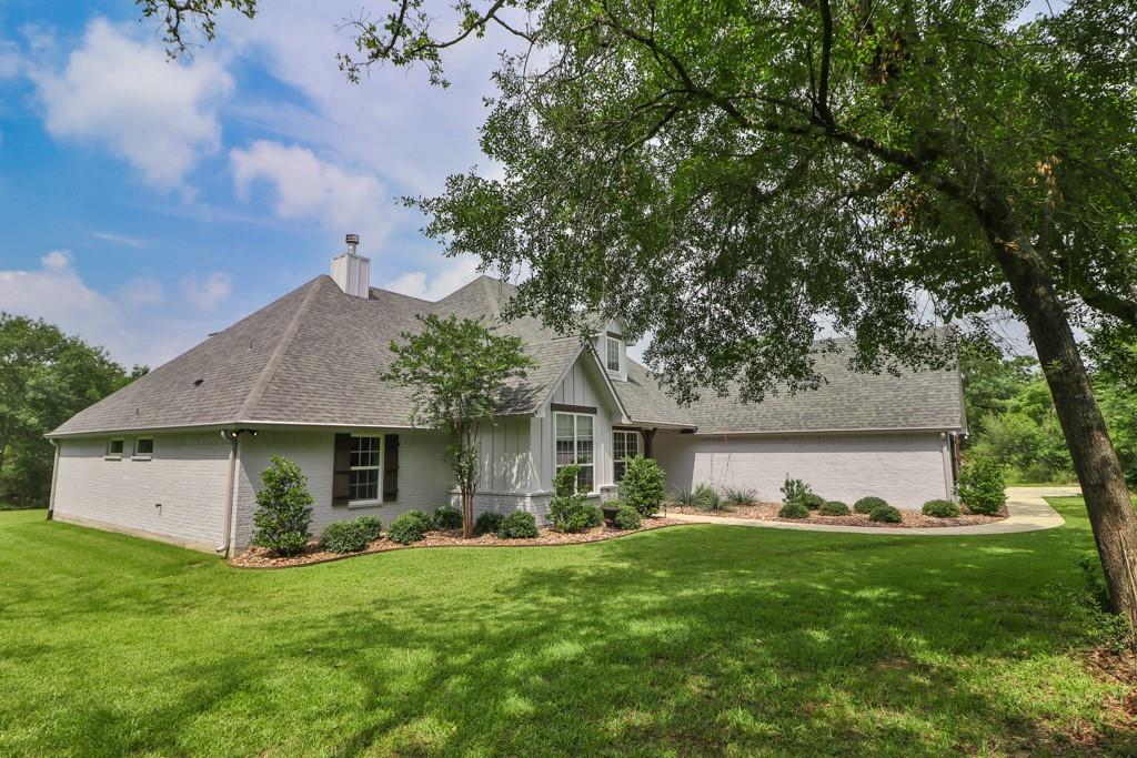 a front view of house with yard and green space