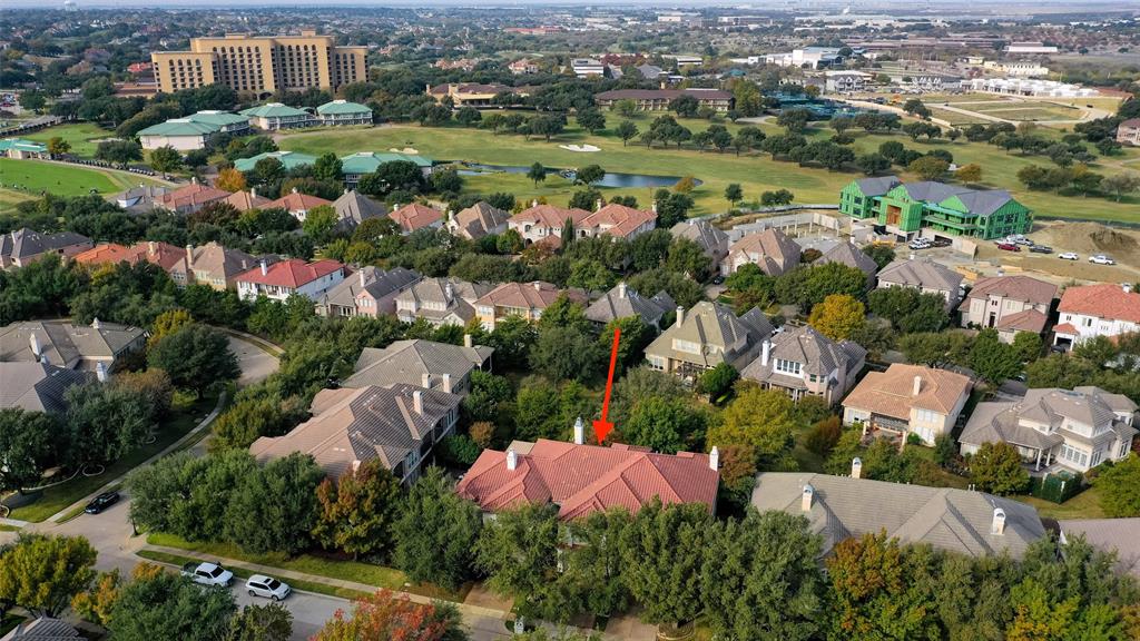 an aerial view of residential houses with outdoor space and trees