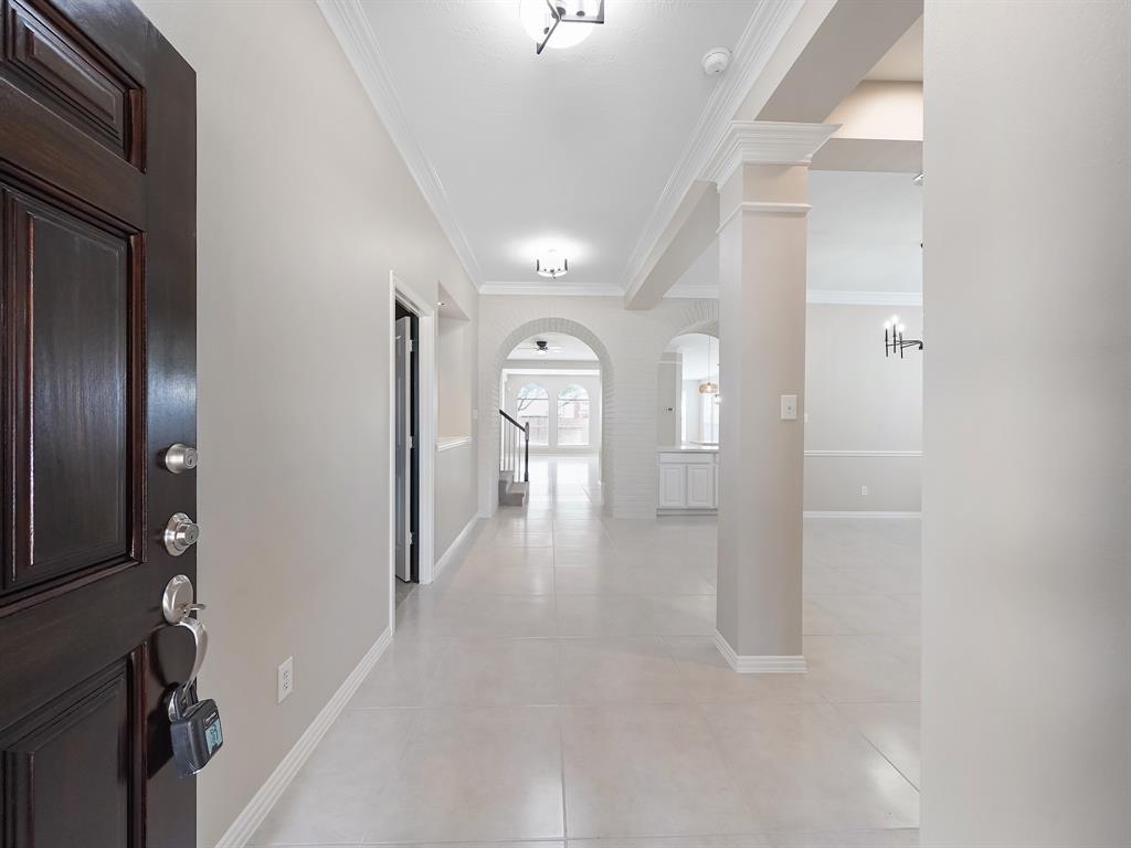 Welcoming Entry with high ceilings and beautiful front door that sets the tone for the home